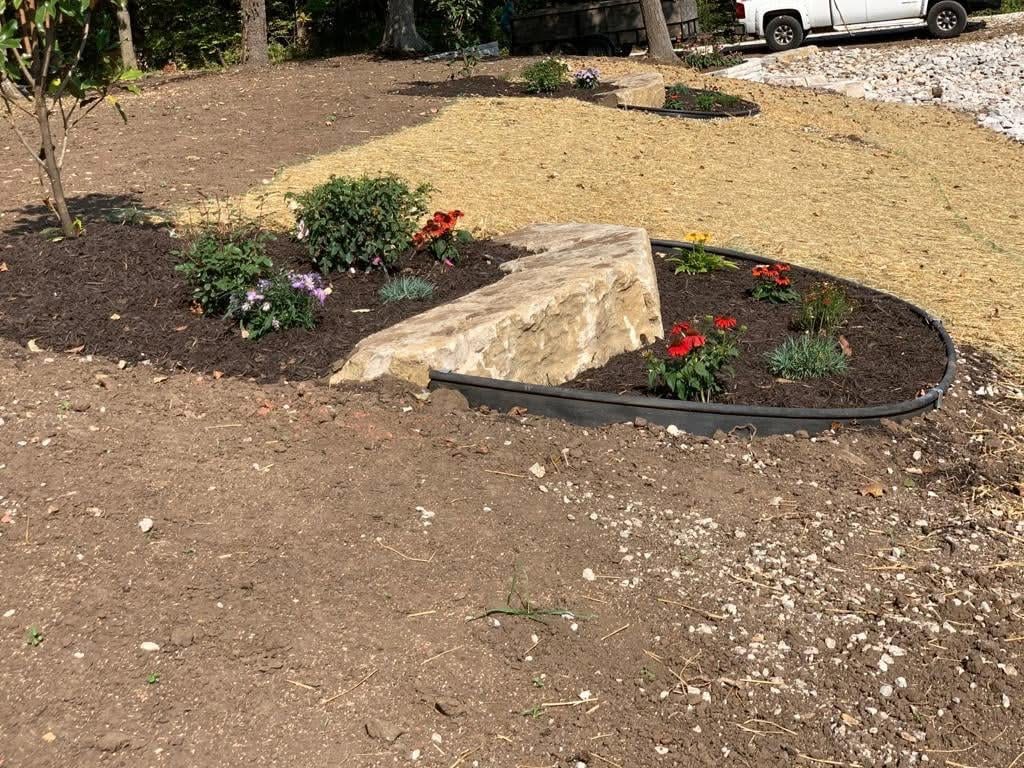 Natural boulder garden bed with flowers